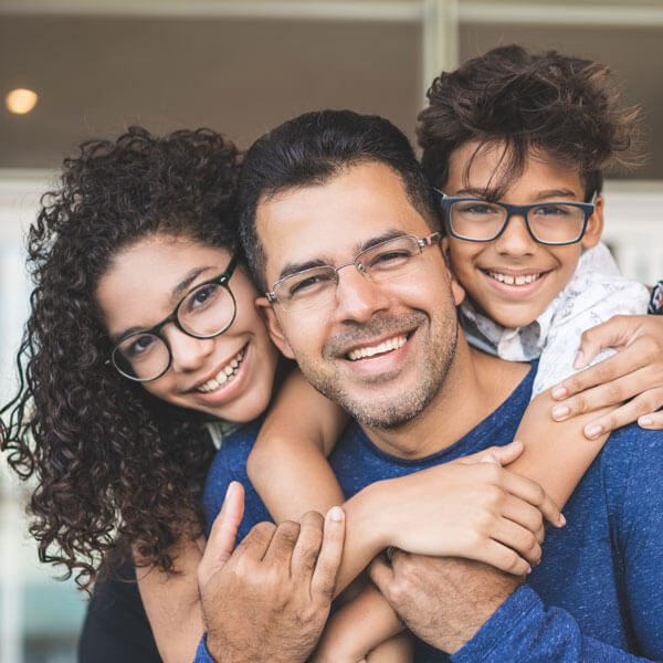 father with two kids hugging and smiling