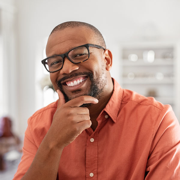 Mature man smiling with hand under chin